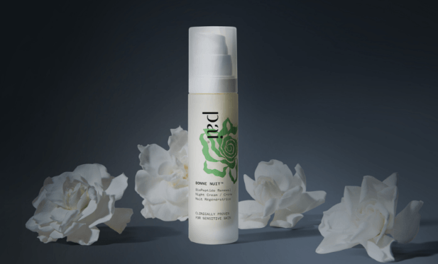 Pai Bonne Nuit Peptide Night Cream with white freesia flowers on dark background