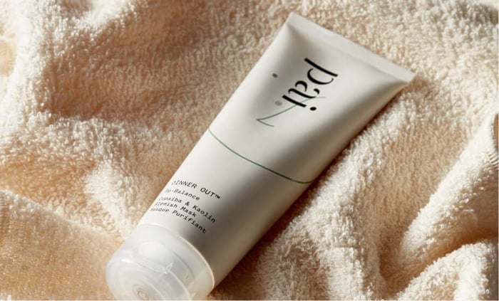 Pai Dinner Out Instant Calm Exfoliating Face Mask tube in white packaging nestled in soft cream towel