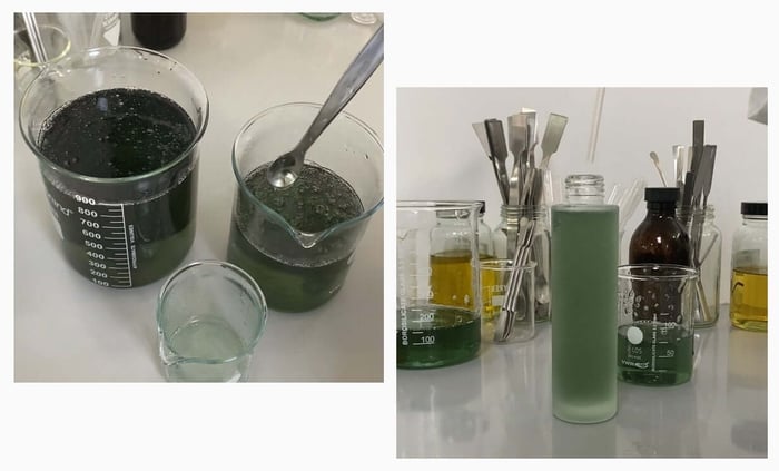 Laboratory beakers containing green PHAZE foam cleanser formulation with measuring tools and amber bottles