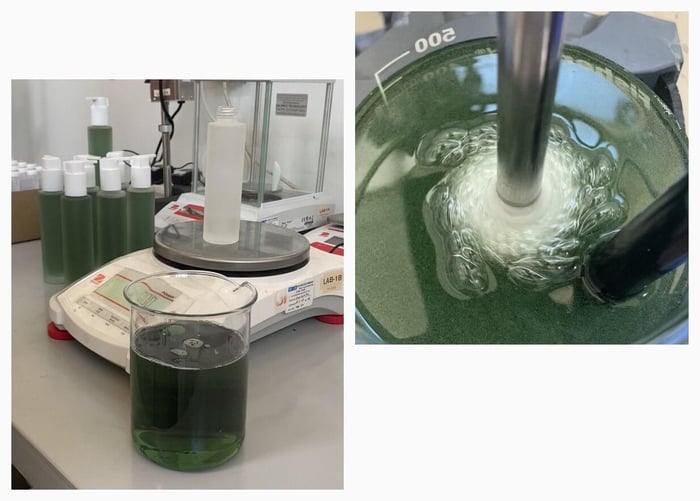 Green PHAZE oil cleanser being mixed in laboratory beaker during formulation process