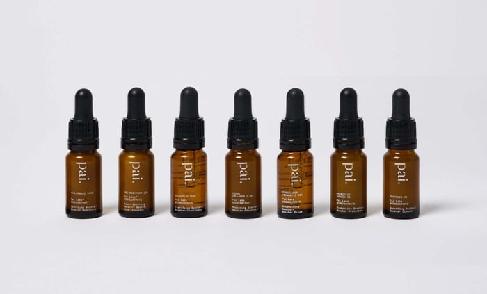 Seven Pai Skincare booster serums in amber glass bottles with black droppers, lined up showing different active ingredients for sensitive skin