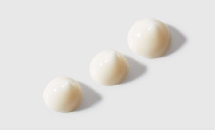 Three dome-shaped applications of Feather Canyon eye cream showing lightweight, cloud-like texture on white background