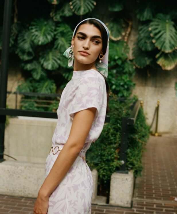 Model in lilac RIXO dress with glowing skin backstage at London Fashion Week