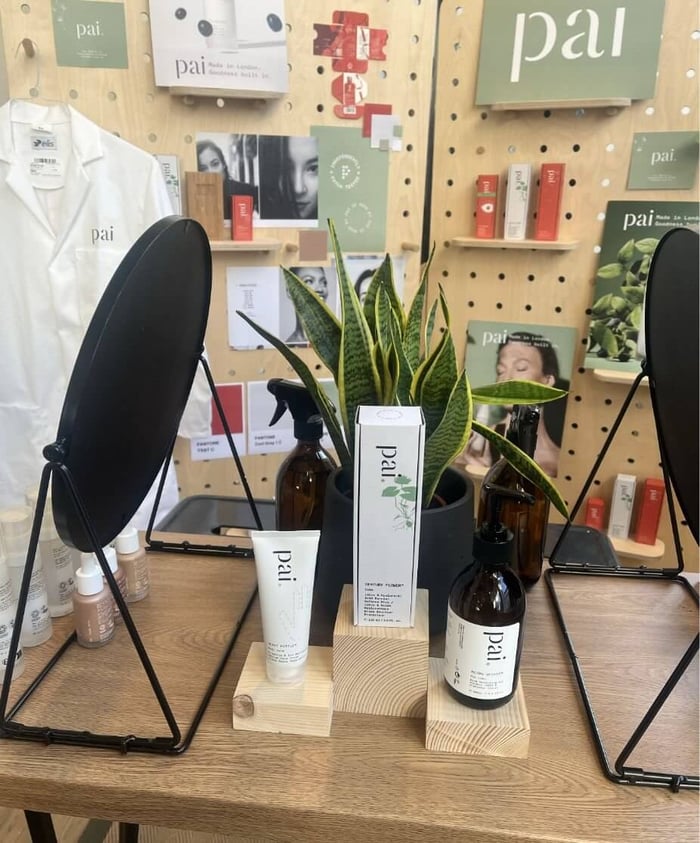 Pai Skincare products displayed at London Fashion Week backstage area with pegboard wall showing natural skincare range
