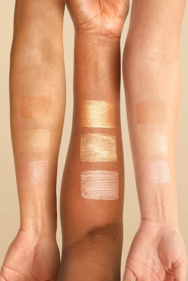 Three arms showing swatches of Pai Glow Drops in Bronze, Champagne and Rose Gold shades on different skin tones
