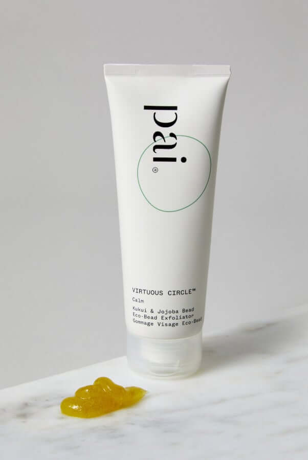 Pai Virtuous Circle Kukui & Jojoba Bead Eco-Bead Exfoliator tube with golden jojoba texture on marble surface