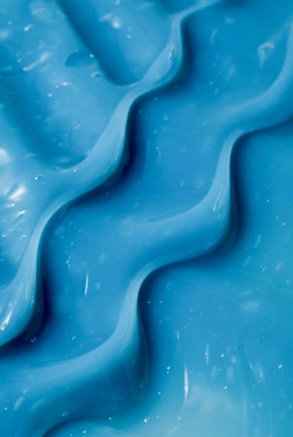 Close-up texture of bright blue Resurrection Girl hydrating face mask showing smooth, creamy consistency