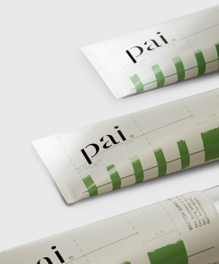 Three tubes of Pai After Sun cooling gel with distinctive green brush-stroke pattern on white packaging