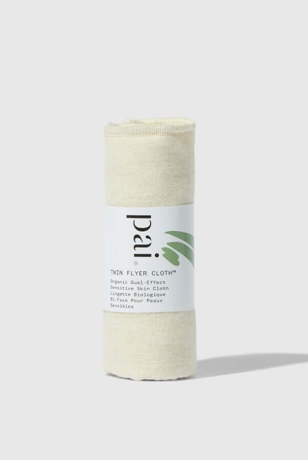Pai Twin Flyer organic muslin face cloth in natural cream color, rolled and standing upright on white background