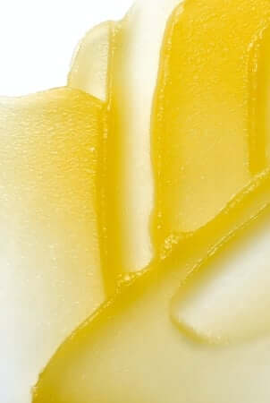 Golden balm texture close-up showing rich, moisturising consistency for dry hand care