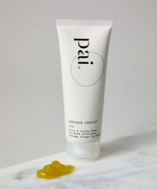 Pai Virtuous Circle Exfoliating Cleanser with golden gel texture on white marble surface for dry skin care