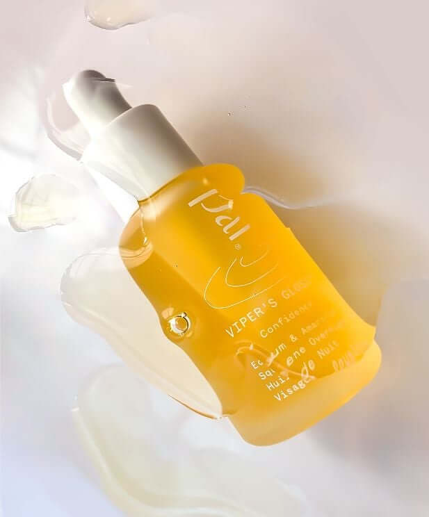 Golden Pai Rosehip BioRegenerate Oil bottle with white pump dispenser on flowing white fabric background