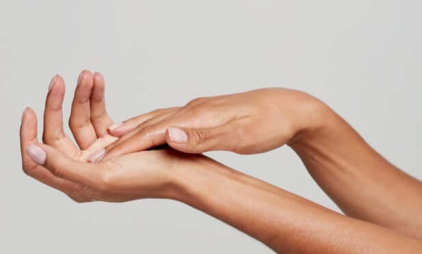 Hands applying moisturiser showing smooth, hydrated skin texture for glycerin skincare benefits