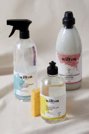 Three Wilton eco-friendly cleaning products with natural sponge - glass spray bottle, refill pouch, and serum bottle