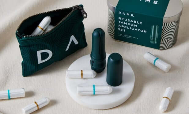 DAME reusable tampon applicator set with organic cotton tampons in dark green case on cream background