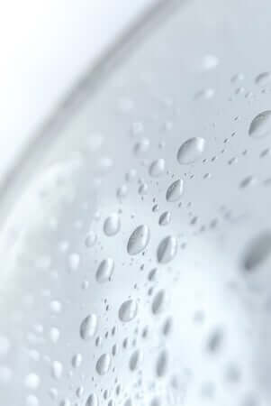 Close-up of water droplets on smooth skin surface showing natural hydration and moisture balance