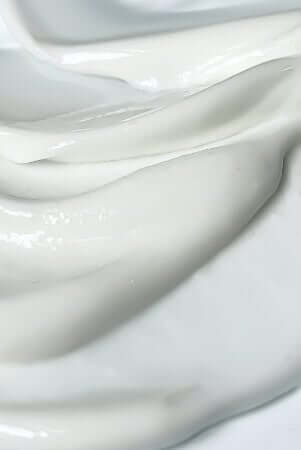 Close-up of white moisturiser cream texture showing smooth, creamy consistency ideal for combination skin care