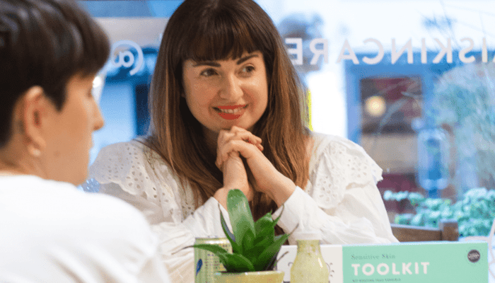 Life coach Lucy Sheridan smiling during skincare consultation at Pai Skincare pop-up store
