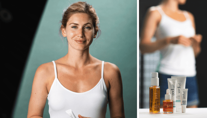 Model Hellana with natural makeup and clear skin wearing white tank top, with Pai Skincare products for sensitive skin visible in background