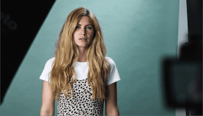 Portrait of blonde model Hellana with natural glowing skin wearing white t-shirt and polka dot top