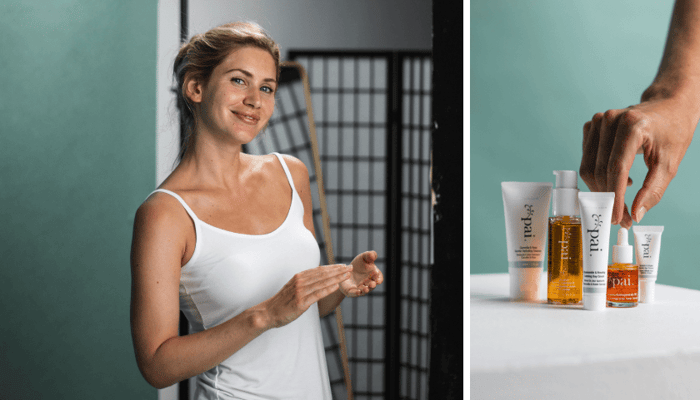 Woman in white tank top smiling in modern bathroom beside Pai Skincare products including Rosehip BioRegenerate Oil and cleanser on white surface
