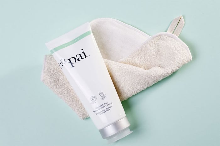 Pai Camellia & Rose Gentle Hydrating Cleanser tube with cream-colored muslin cloth on soft mint green background