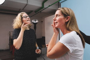 Two women applying Pai skincare products naturally without retouching, showing authentic skin textures
