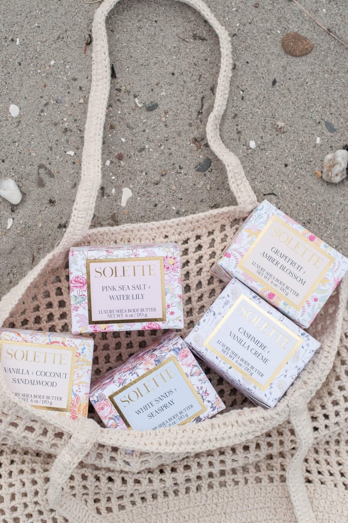 body butter vs. body lotion beach bag filled with body buters