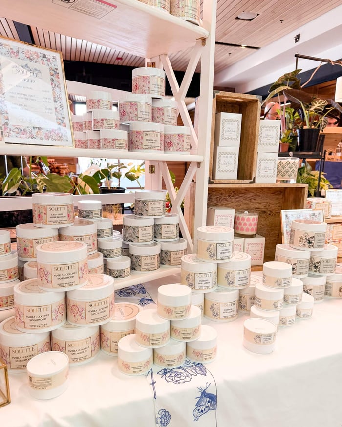 a selection of jars of our body scrubs and body washes on a table
