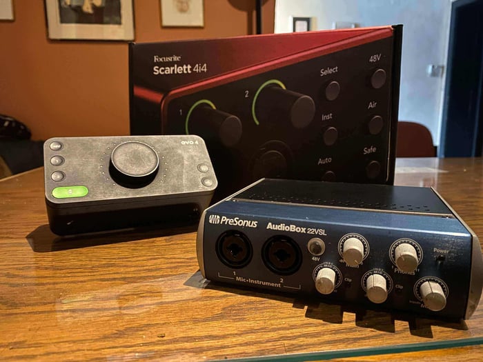 Common interfaces for home studios include the Focusrite Scarlett, Audient EVO, and PreSonus AudioBox.