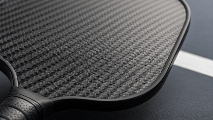Pickleball paddle surface texture — carbon fiber paddle face close up