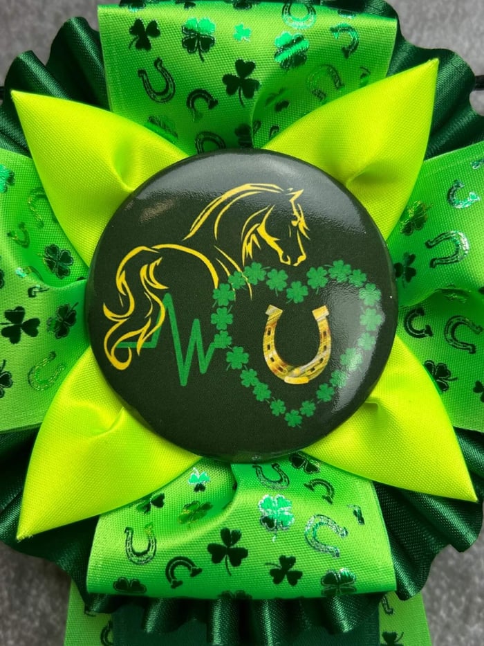 Close up of custom Iverson rosette award with green Clover & Horseshoes ribbon designs.