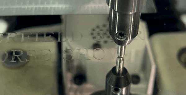 Engraved in progress on a silver picture frame award