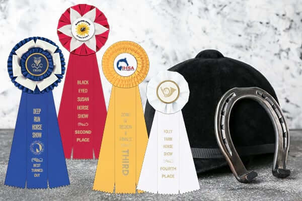 Rosette horse show awards in standard place colors: blue for first, red for second, yellow for third, and white for fourth.