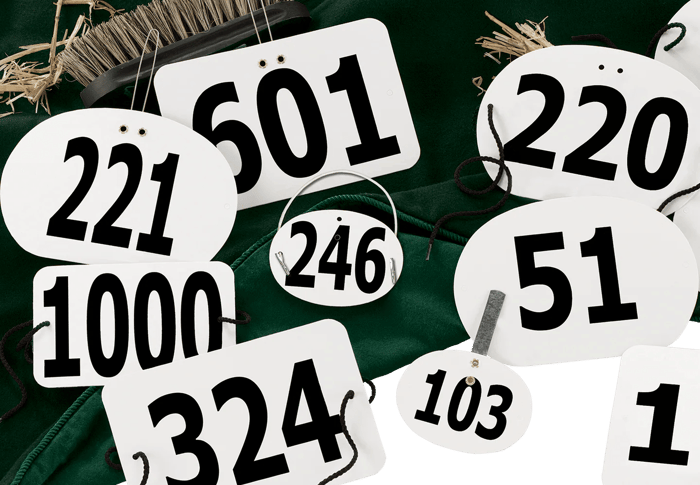 Rider numbers cut on an original Heidelberg press at Hodges Badge Company.