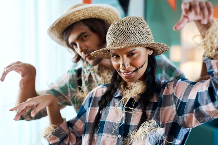 Two people dressed as scarecrows - murder mystery parties are fun.