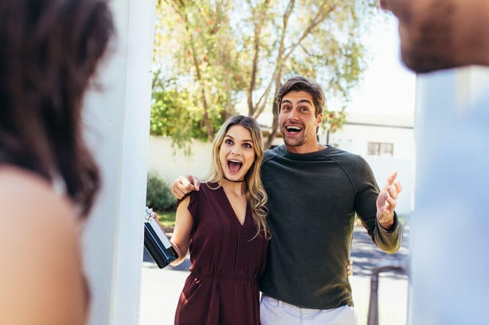Party guests arriving to a mystery party game.