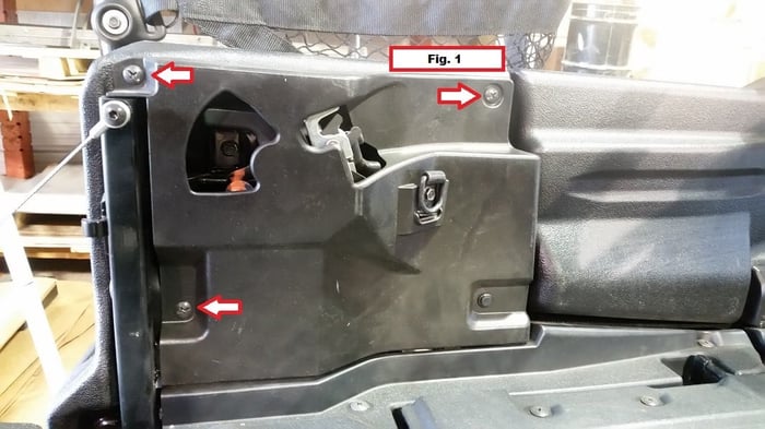 Removing the three Phillips screws from the inner bed side panel on a Honda Pioneer 1000-6