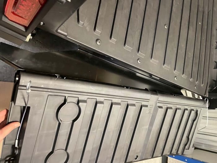 The four existing mounting holes in the bed of a Ranger SP 570 with the tailgate removed