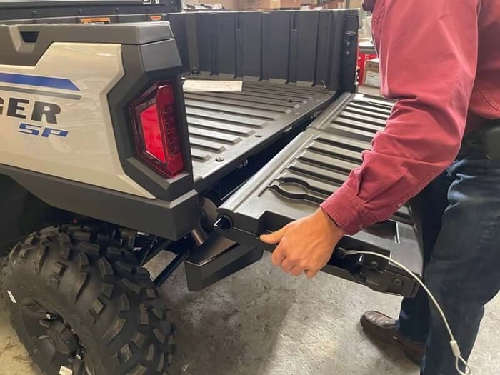 Removing the tailgate from a Polaris Ranger SP 570 by opening it past 90 degrees