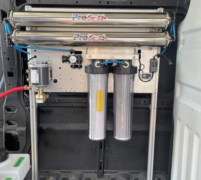 drone cleaning hydro panel on a van wall