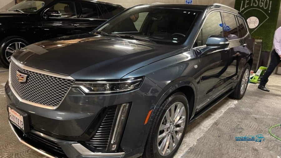 Dark gray Cadillac XT6 with clean glossy finish after car wash and wax service in San Diego
