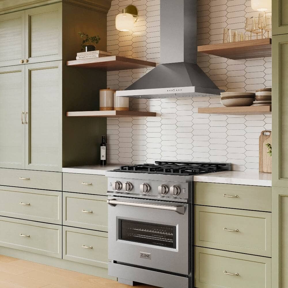 A wall mount range hood above a range in a kitchen