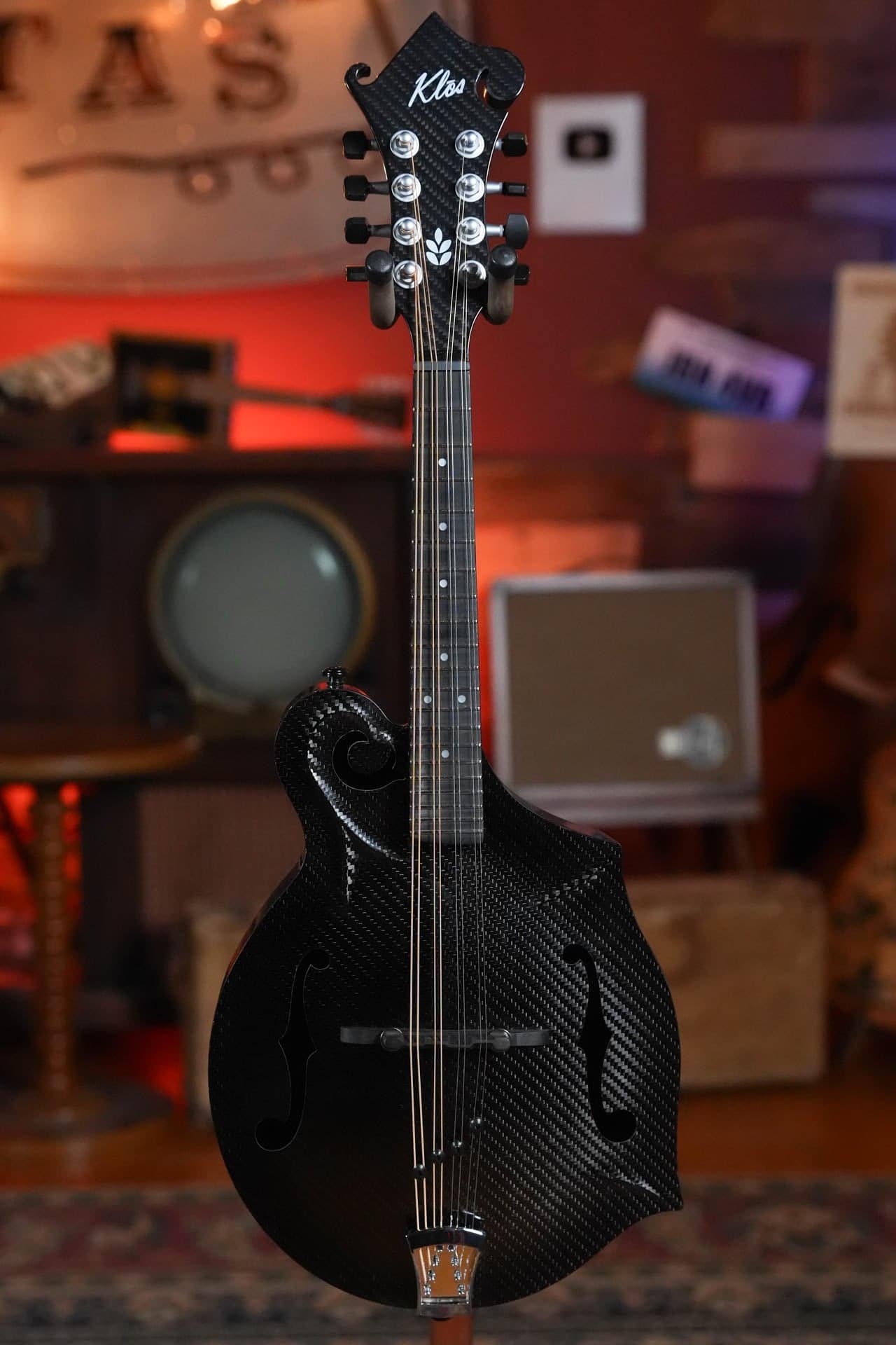 Black Twill KLOS F-style, a carbon fiber mandolin for touring, standing in The Acoustic Shoppe showroom