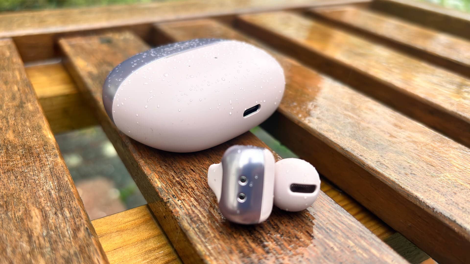 Shokz OpenDots One earbuds resting on a vibrant, colorful surface