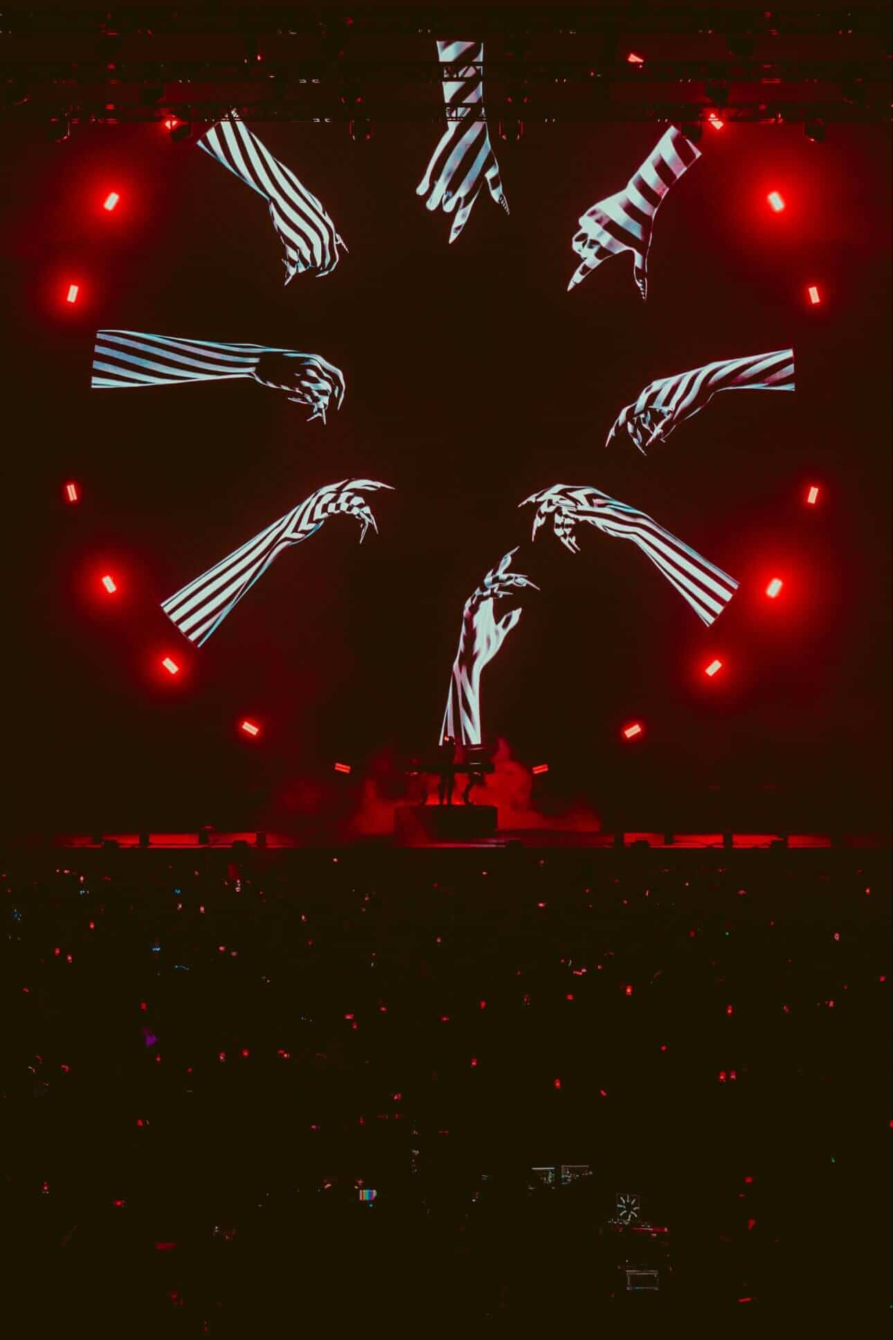The stark lighting highlights the raw energy of her performance.