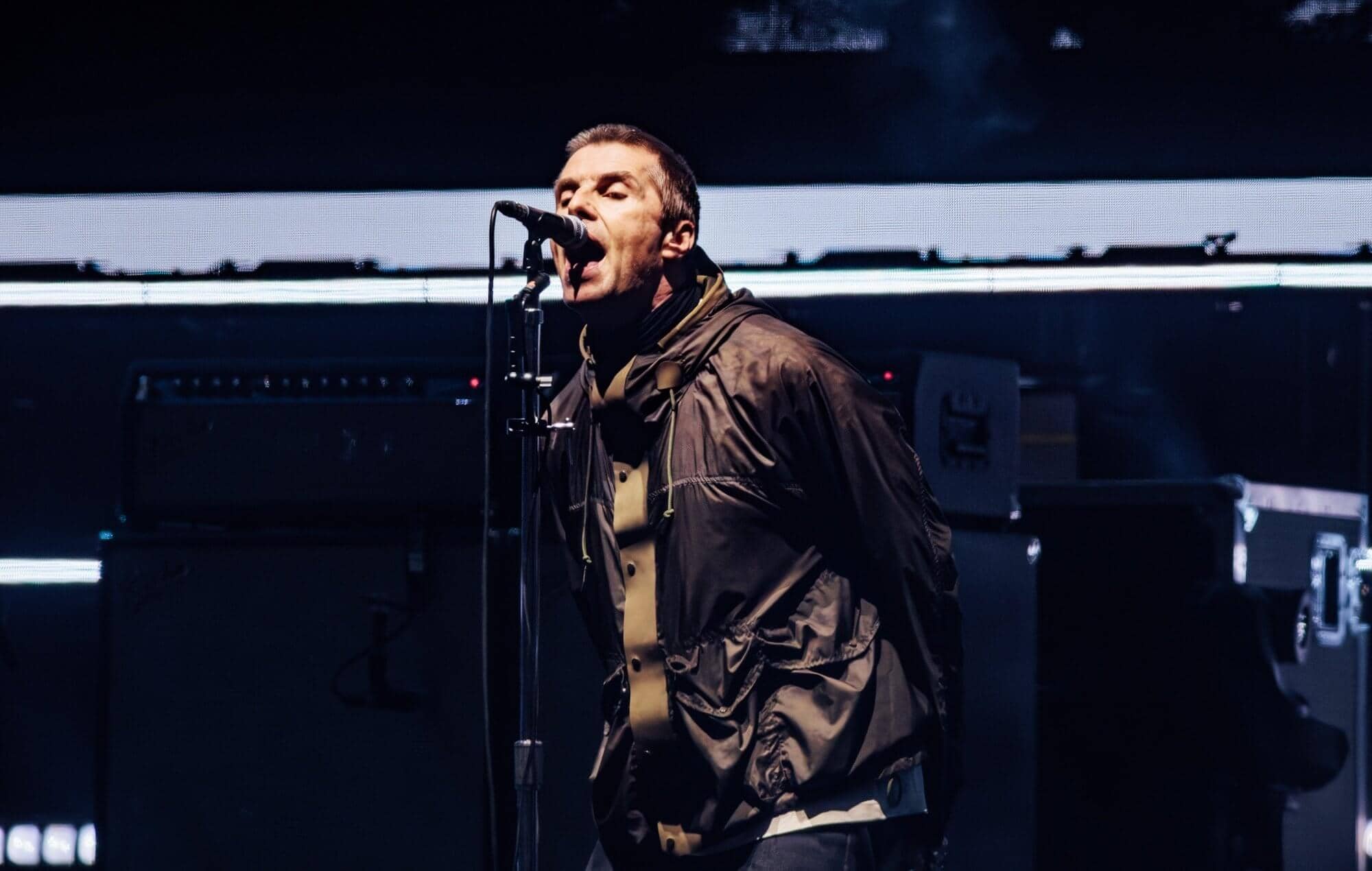 Liam Gallagher performing live on stage with Oasis in Cardiff