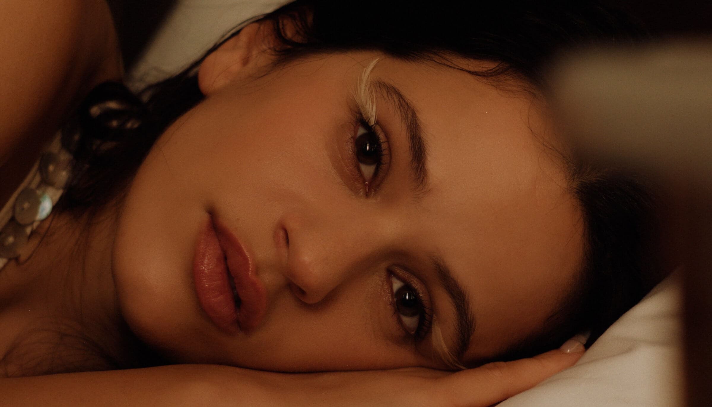 Rosalía enveloped by orchestra musicians in 'Berghain' music video