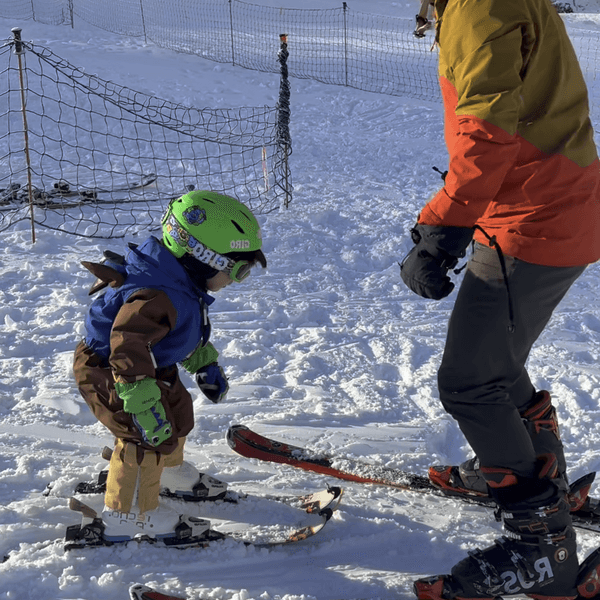 Toddler standing independently on skis