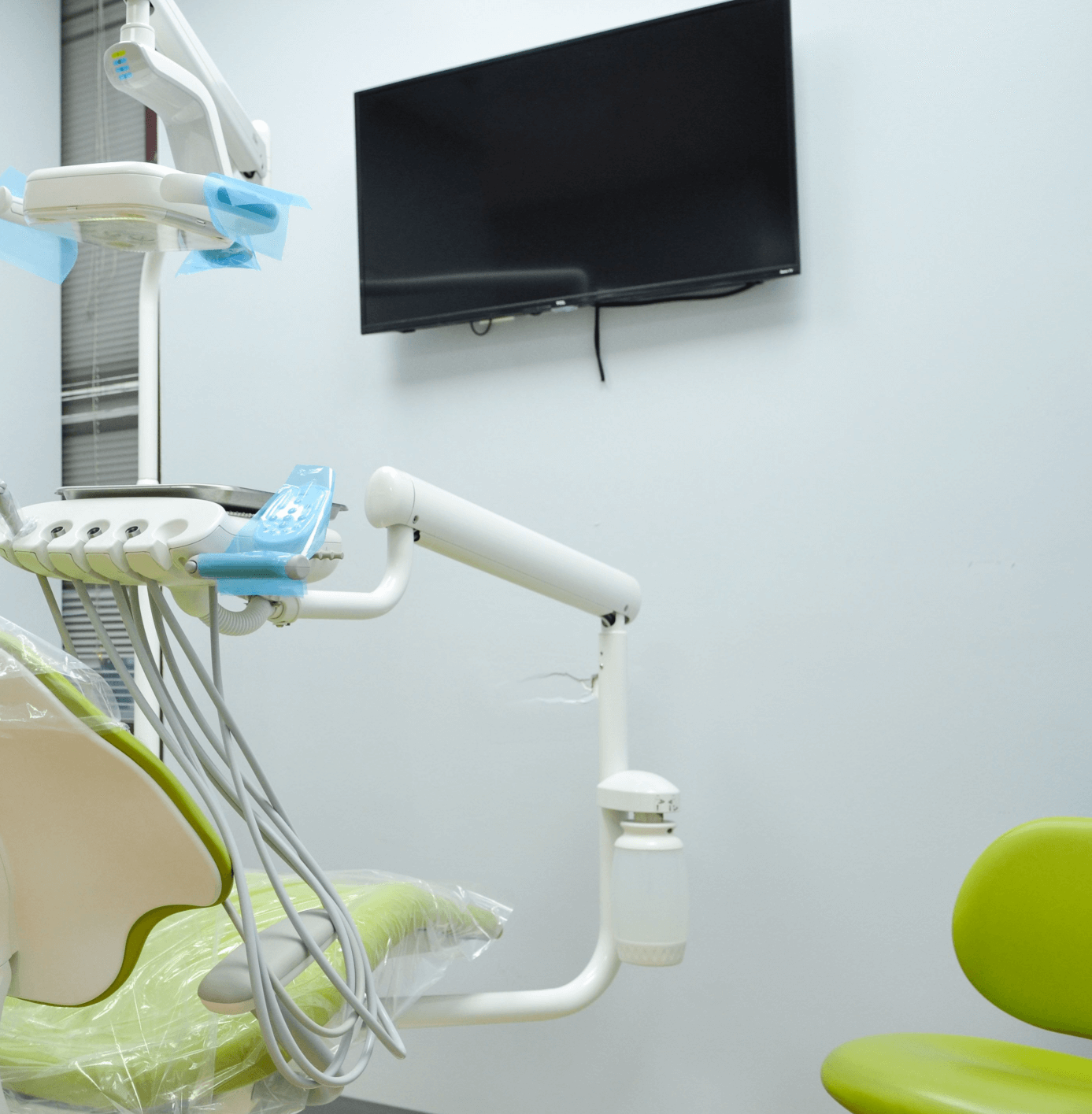 A dental chair in front of a monitor